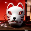 Masque japonais Kitsune malicieux blanc en céramique avec motifs rouges et noirs, cordon rouge, décor traditionnel renard sacré